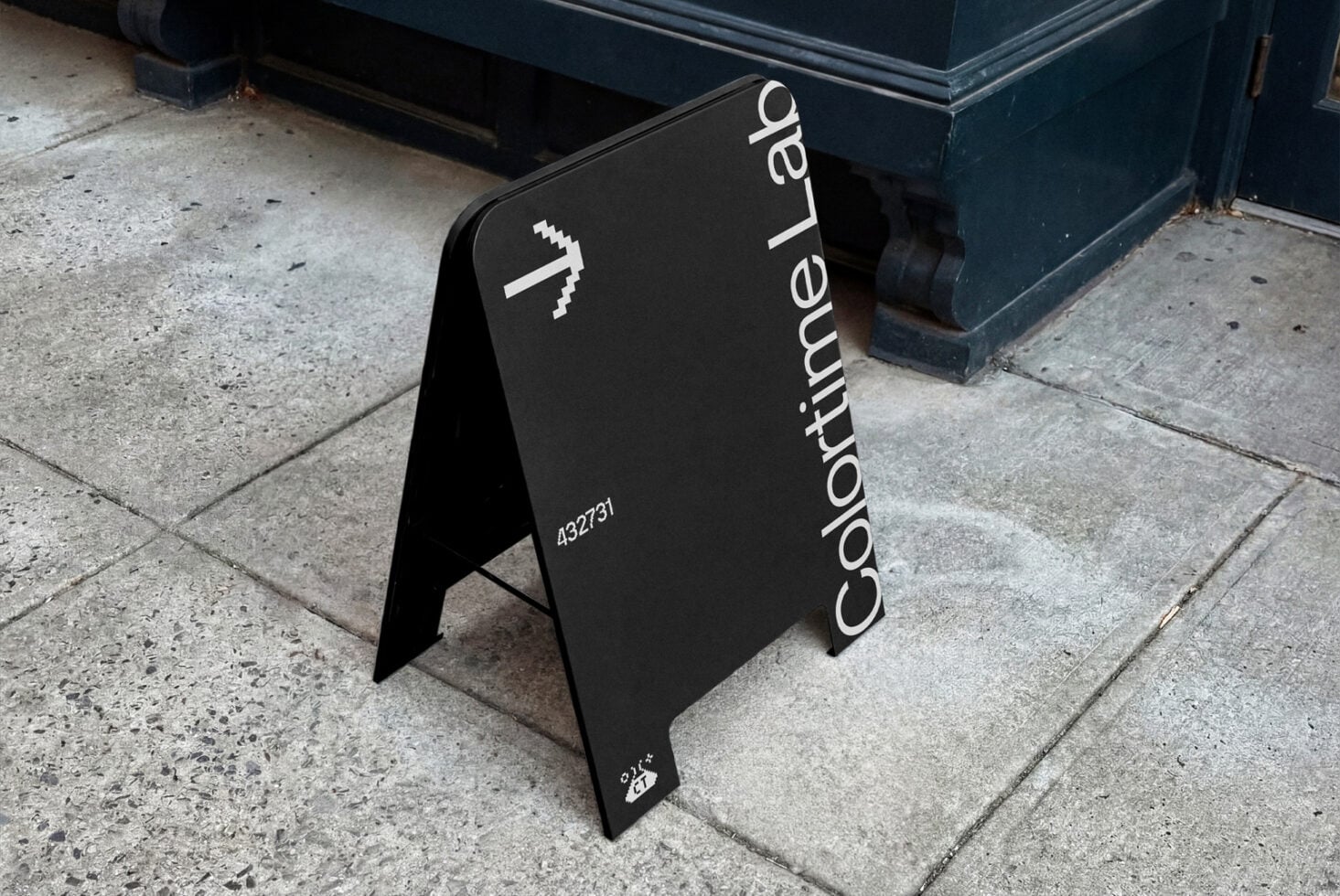 Black A-frame outdoor sign featuring Coordinate Lab text vertically