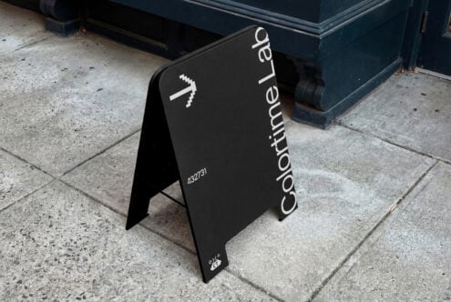 Black A-frame outdoor sign featuring Coordinate Lab text vertically