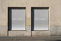 Minimalist storefront with two identical black-framed blank poster mockup templates