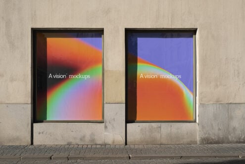 Urban storefront window showing dual framed displays with colorful gradient backgrounds