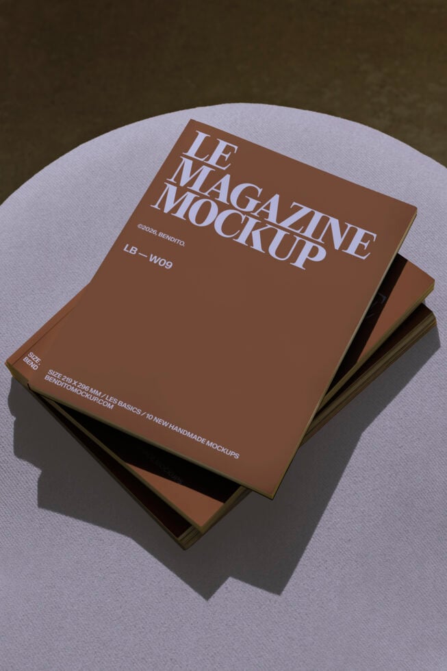 Stack of brown magazine mockups arranged on white circular platform with shadows