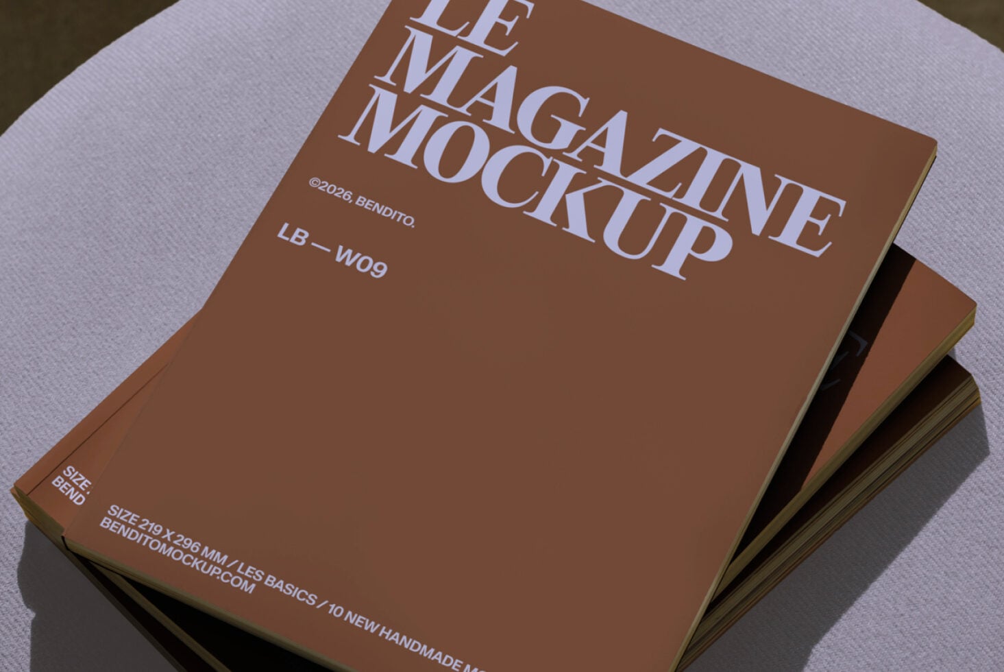Angled stack of tan magazine mockups with white text on soft purple background
