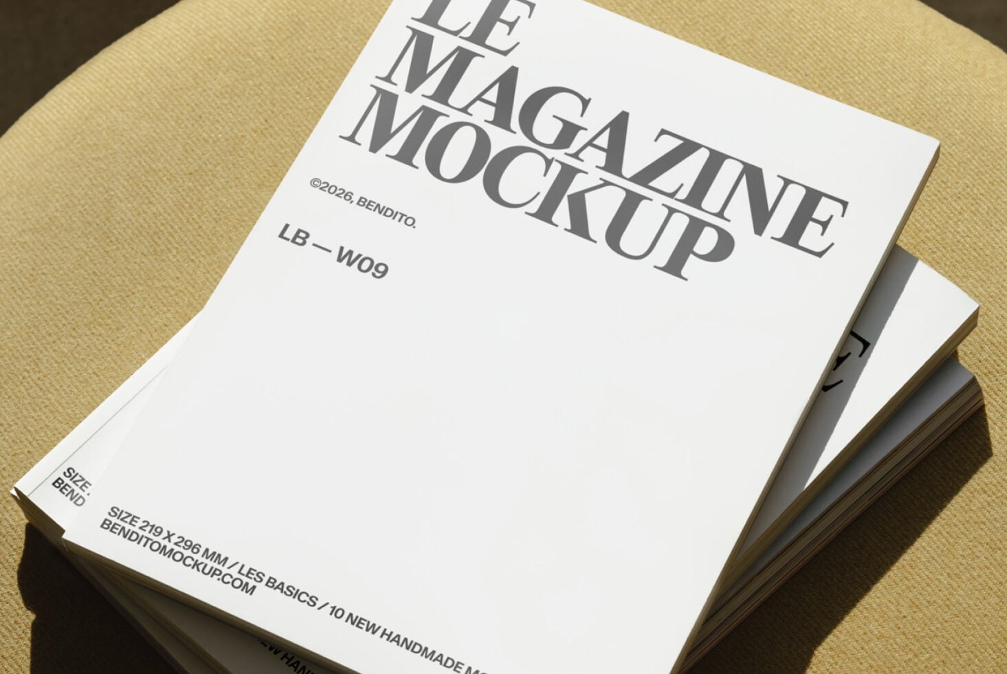 Stacked magazines with serif typography on cream background with textured surface