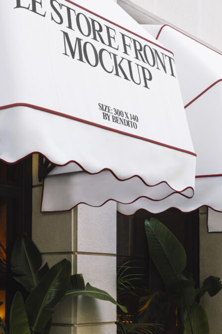 Deep burgundy curved awning mockup over shop window with plants
