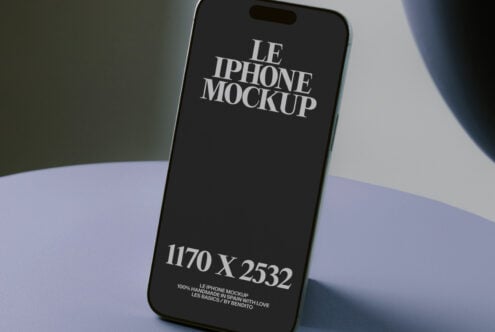 Black iPhone screen displayed at angle on pastel surface with dramatic light