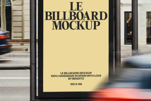 Close up of yellow billboard display on street shelter with traffic blur