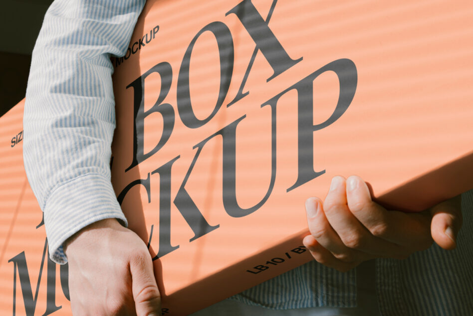 Hands holding peach colored paper with serif typography mockup in sunlight
