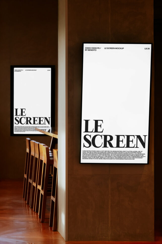 Two white framed posters on rustic brown wall showing LE SCREEN with chair detail