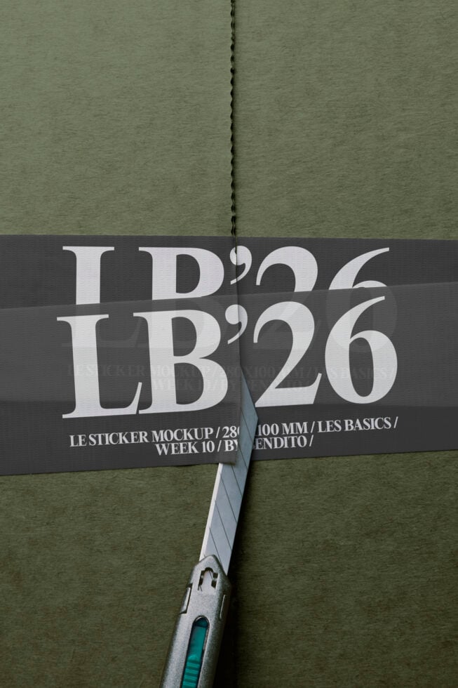 Opened sticker mockup showing LB'26 typography on sage green paper with scissors
