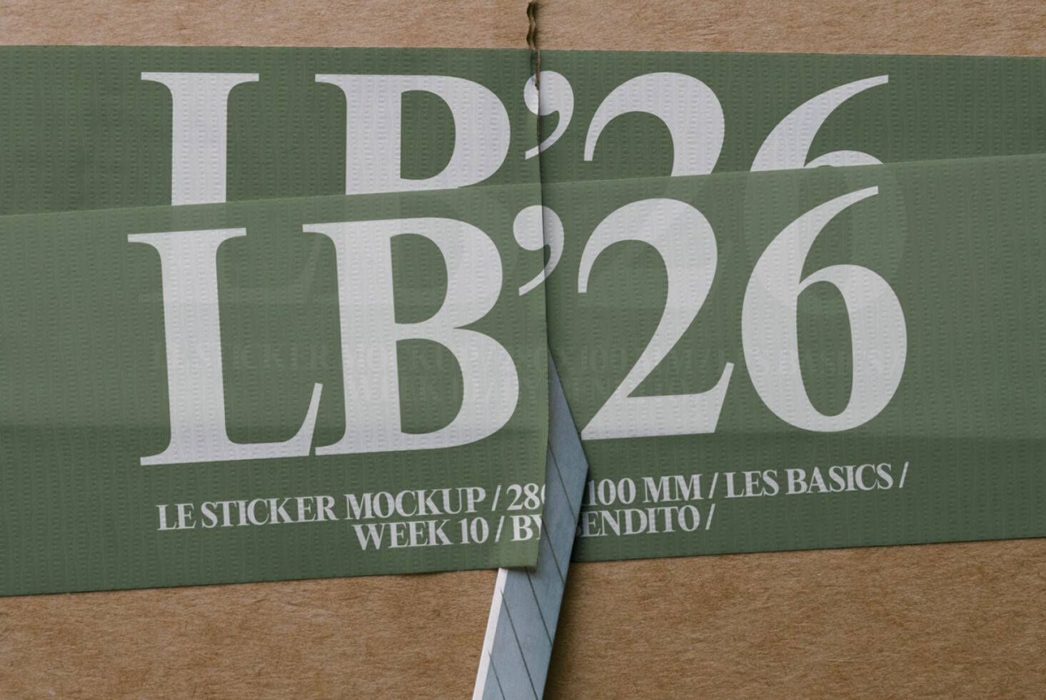 Opened sticker showing LB'26 text on green background with kraft paper underneath