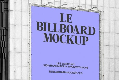 Wide shot of bright blue billboard with Le Billboard Mockup text on white grid wall