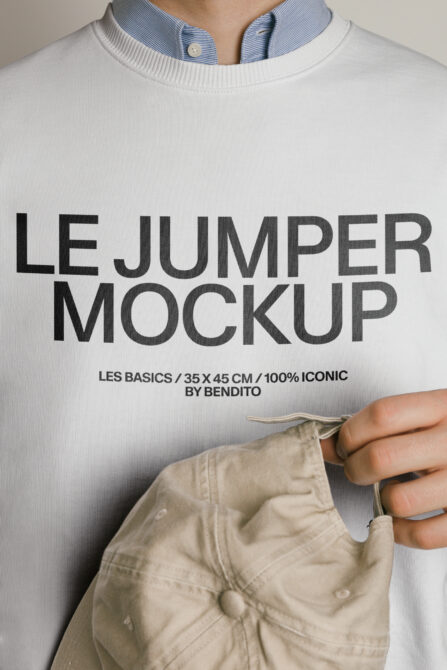 Person wearing white crewneck sweatshirt holding beige fabric