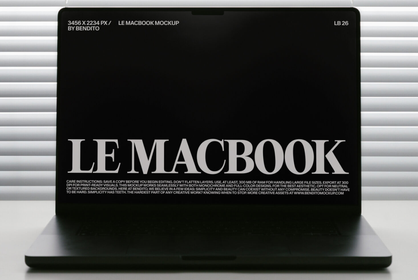 MacBook mockup with black screen showing white serif text against horizontal blinds backdrop
