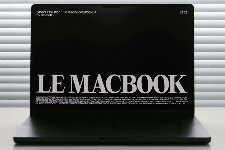 MacBook mockup with black screen showing white serif text against horizontal blinds backdrop