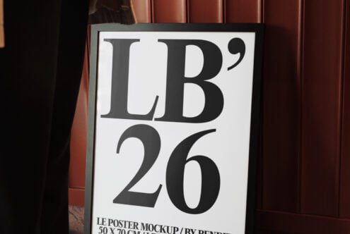 Close-up of framed poster mockup with white background displaying serif typography in gallery space
