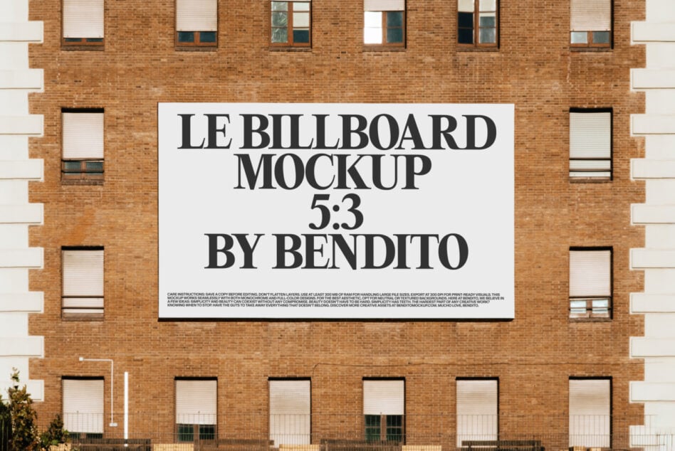 White billboard on brick building displaying Le Billboard Mockup 5:3 by Bendito
