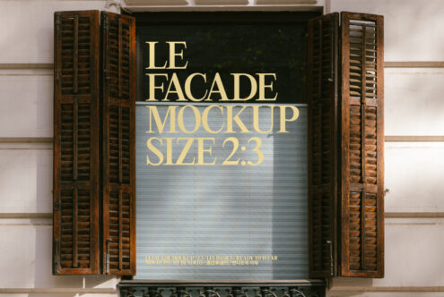 Storefront with vintage wooden shutters displaying gold text on dark green background