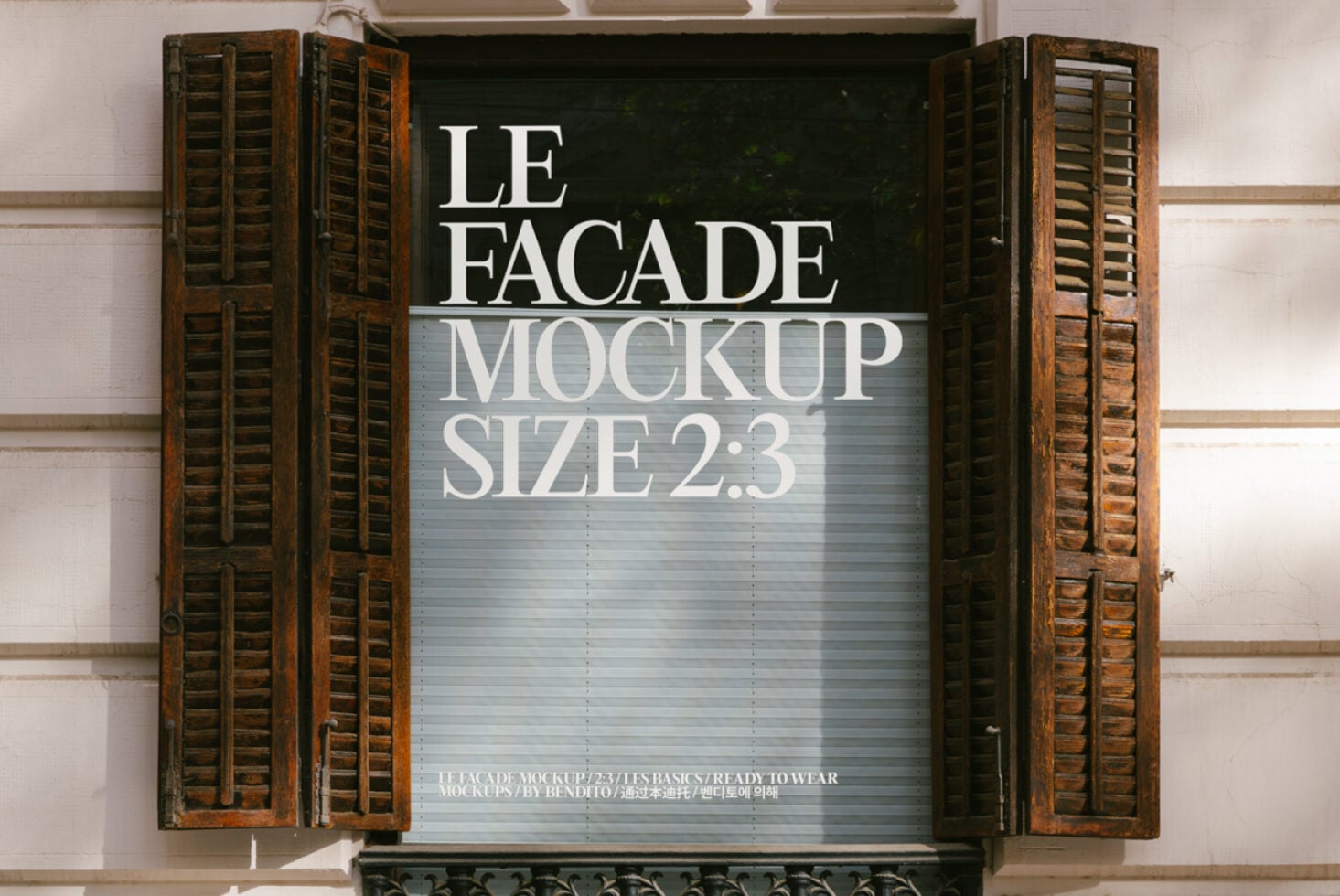 Storefront with vintage wooden shutters displaying white text on light gray background
