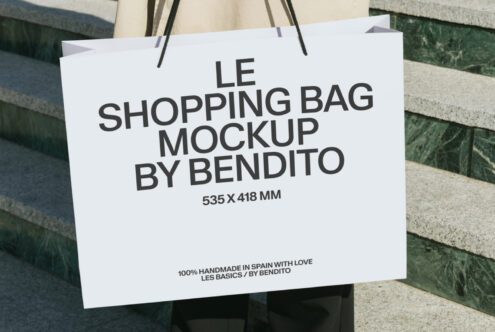 White shopping bag with black rope handles showing product mockup text