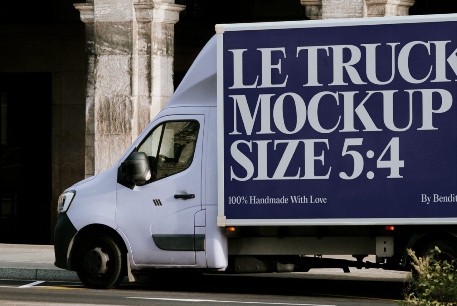 Delivery truck cab close-up showing navy blue billboard wrap on cargo area