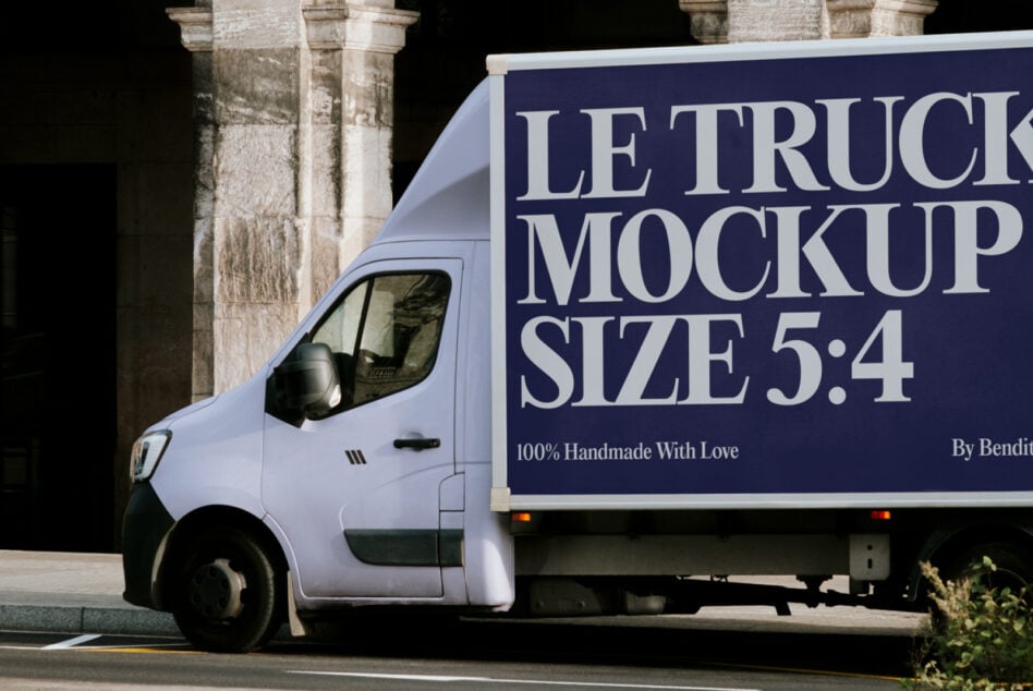 Delivery truck cab close-up showing navy blue billboard wrap on cargo area
