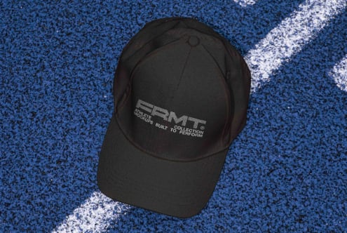 Black cap from above on blue asphalt with white line stripe