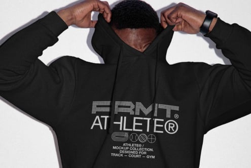 Back view of black hoodie with arms pulling fabric up showing large print