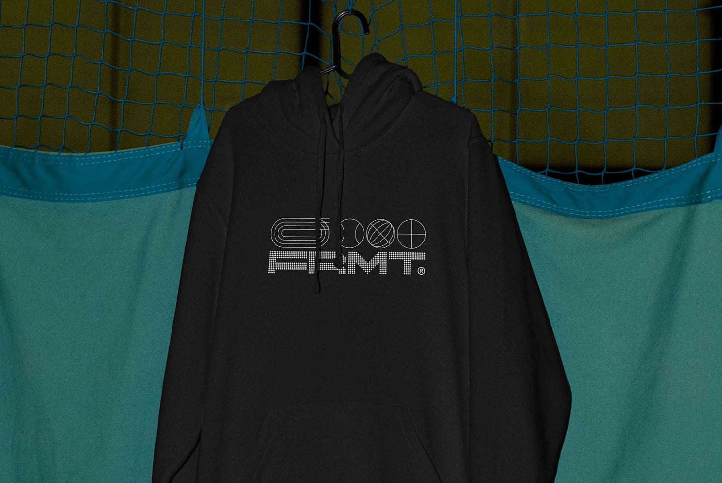 Black hoodie on hanger displaying back logo with geometric shapes design