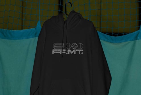 Black hoodie on hanger displaying back logo with geometric shapes design