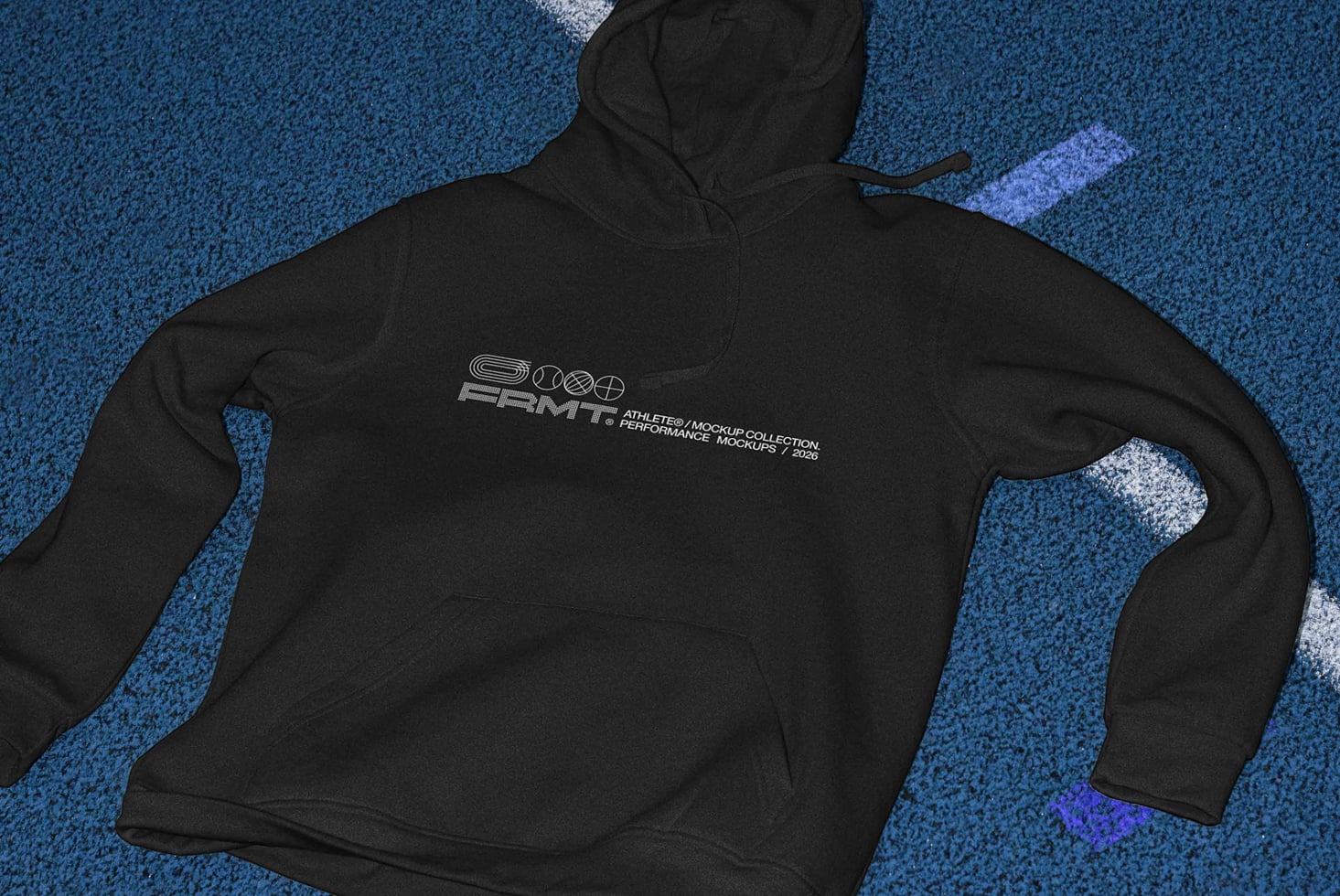 Black hoodie flat lay showing back chest print on blue track surface