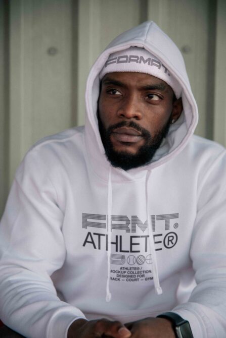 White hoodie sweatshirt with FRMT Athlete mockup collection details worn by person indoors