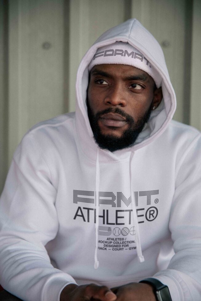 White hoodie sweatshirt with FRMT Athlete mockup collection details worn by person indoors