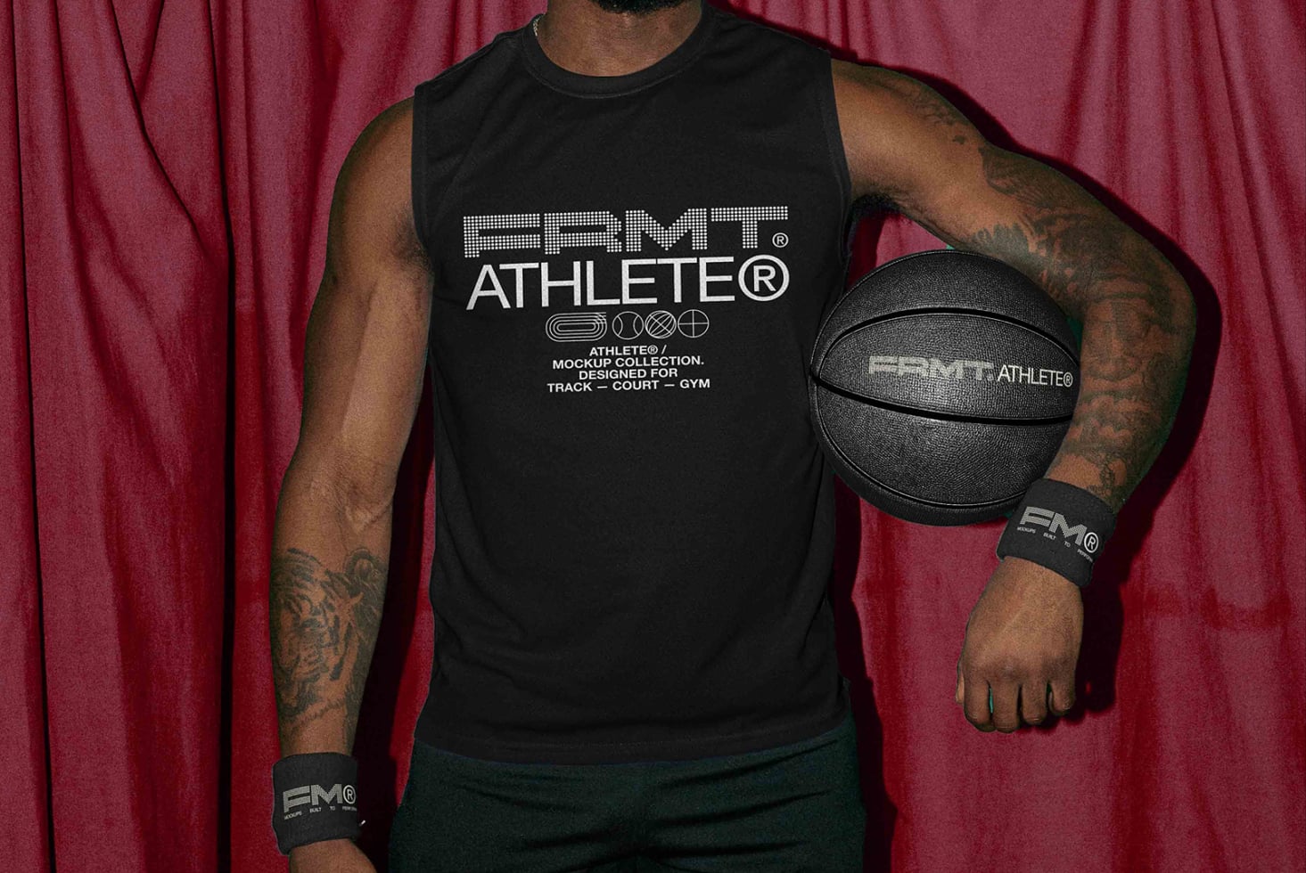 Player in black tank against maroon backdrop gripping black basketball