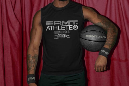 Player in black tank against maroon backdrop gripping black basketball