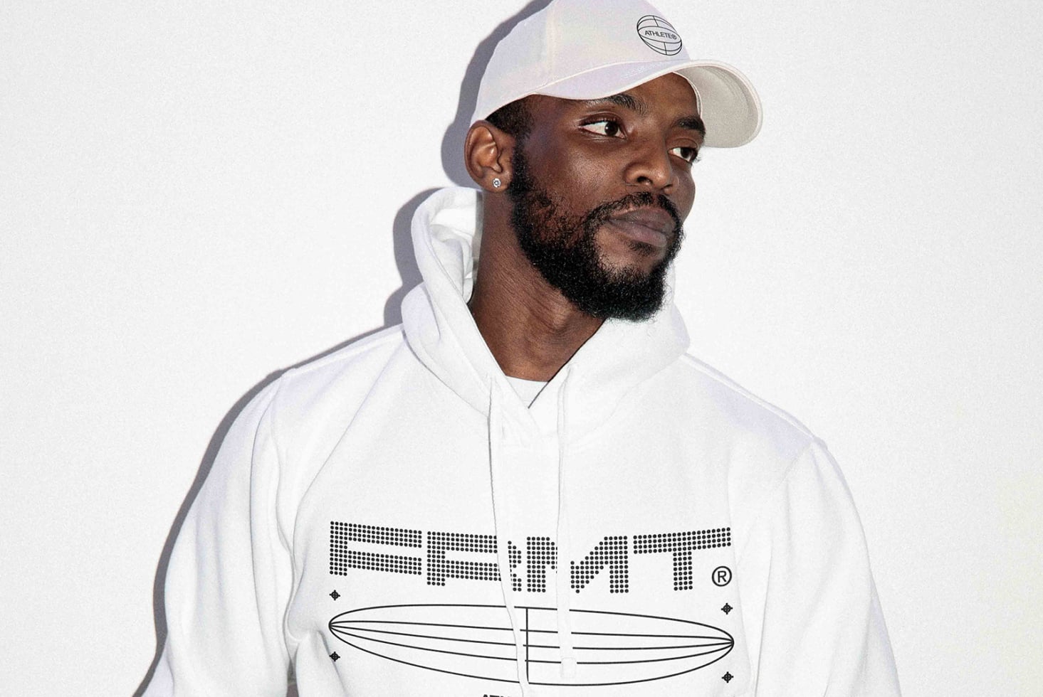 Man modeling white hoodie with geometric surfboard print mockup