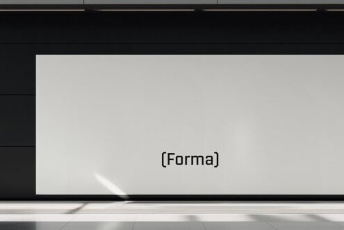 Blank light grey screen mockup mounted on gallery wall with minimal text overlay