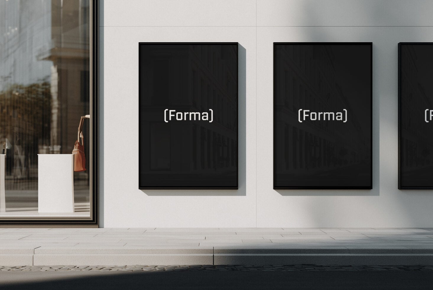 Multiple black framed posters on white gallery wall with Forma branding visible