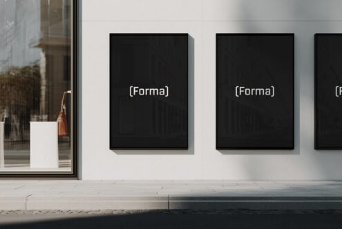Multiple black framed posters on white gallery wall with Forma branding visible