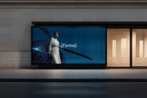 Retail storefront screen displaying woman in white beside blue vehicle scene