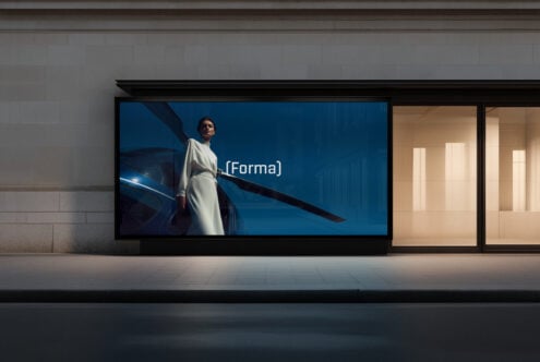 Retail storefront screen displaying woman in white beside blue vehicle scene
