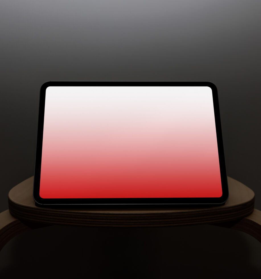 Tablet on wooden stand with red gradient screen, landscape view