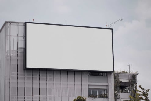 Empty billboard on concrete building exterior ready for design placement
