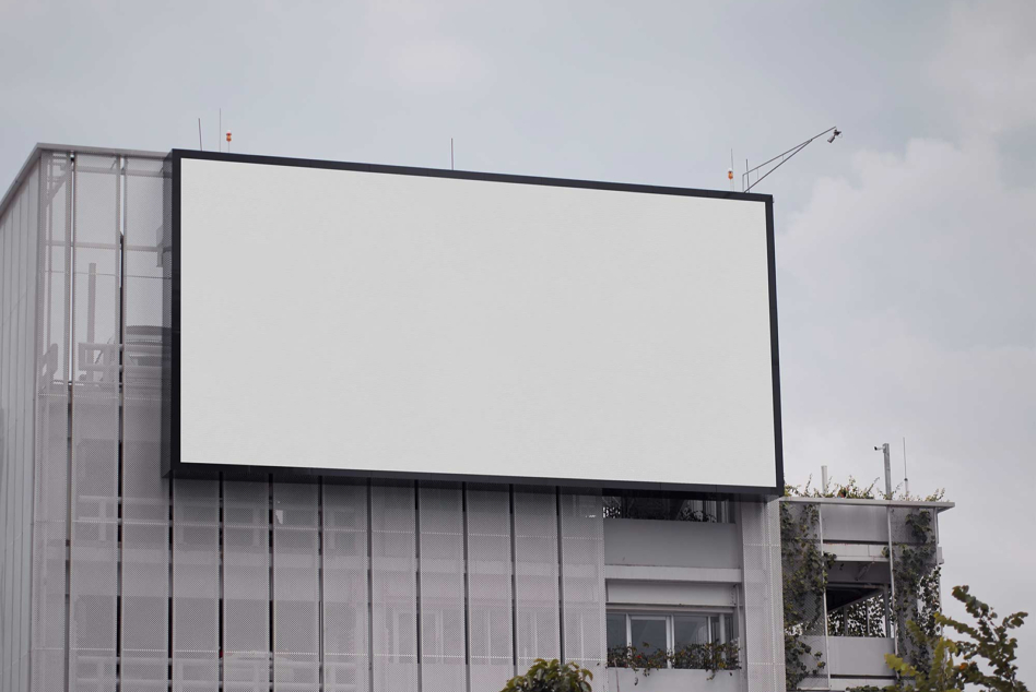 Empty billboard on concrete building exterior ready for design placement