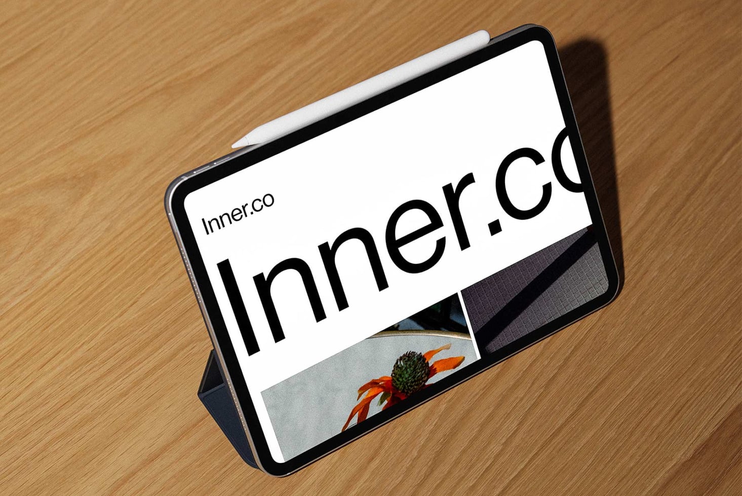 iPad in holder displaying Inner.co branding on wooden surface