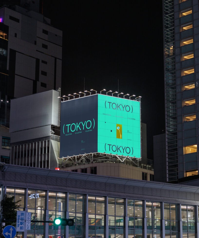 Illuminated billboard at night displaying Tokyo collection with turquoise panel