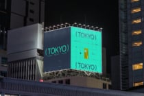 Glowing Tokyo collection billboard at night with mint green display, city backdrop