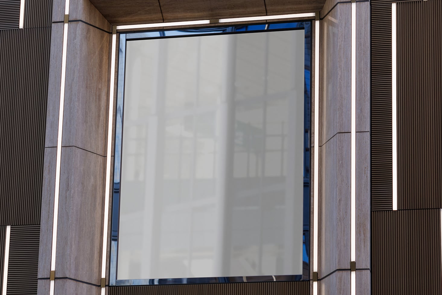 Close-up of empty storefront poster space inside modern concrete entrance with white glow