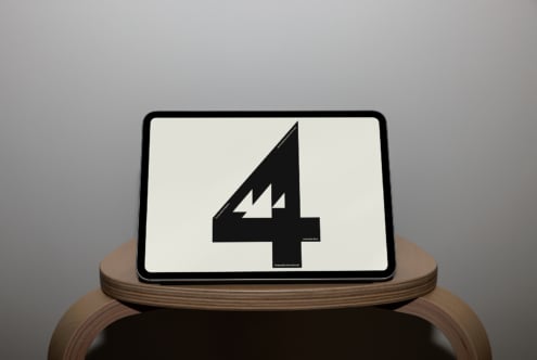 Tablet on wooden stand showing bold black number 4 with lightning bolt detail