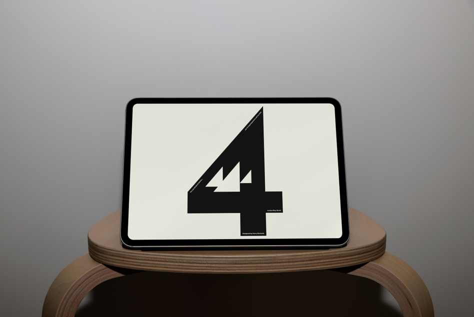 Tablet on wooden stand showing bold black number 4 with lightning bolt detail