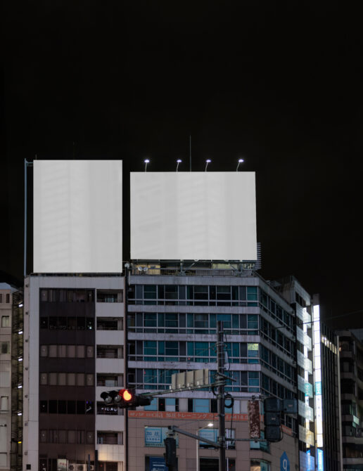 Nighttime urban billboard mockup on building with lit signage setup